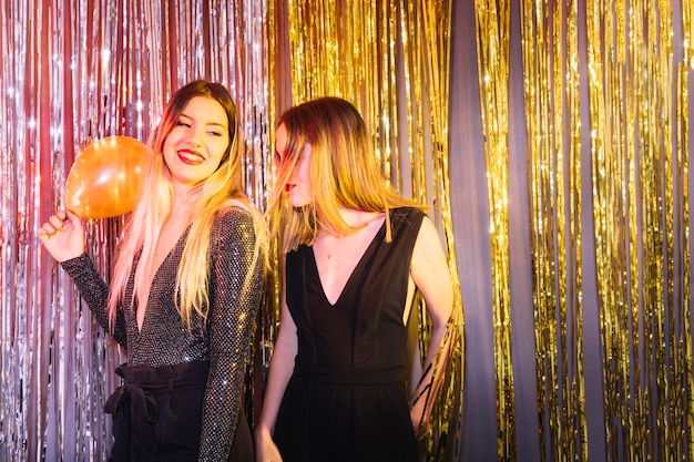 Free photo two girls dancing at new year party