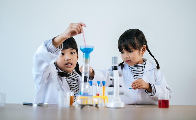 Two girls doing science experiments in a lab. Selective focus.