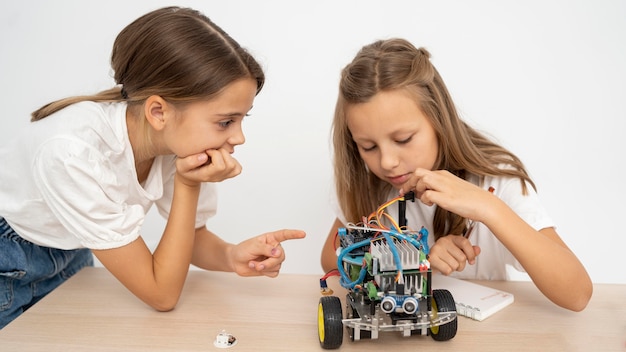 Free photo two girls doing science experiments together