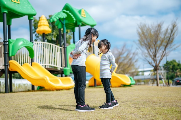 Two girls happily playing in the playground