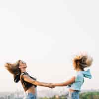 Free photo two girls having fun on rooftop