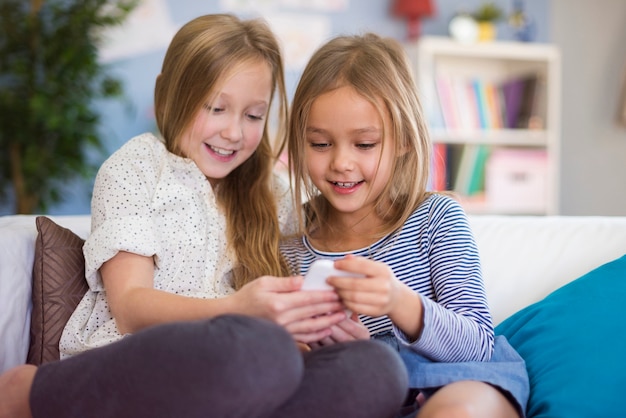 Two girls reading funny message from friend