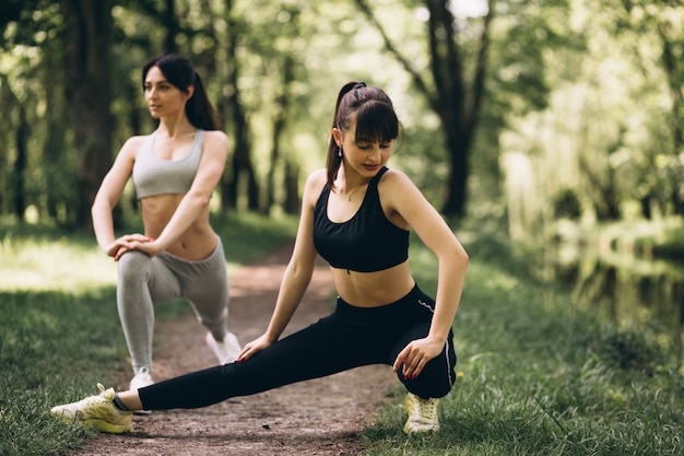 Free photo two girls stretching in park