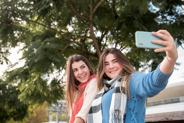 Free Photo two girls taking a selfie