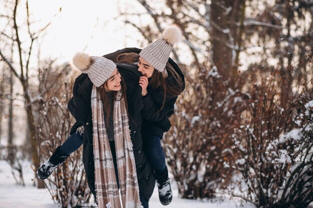 Two girls twins together in winter park