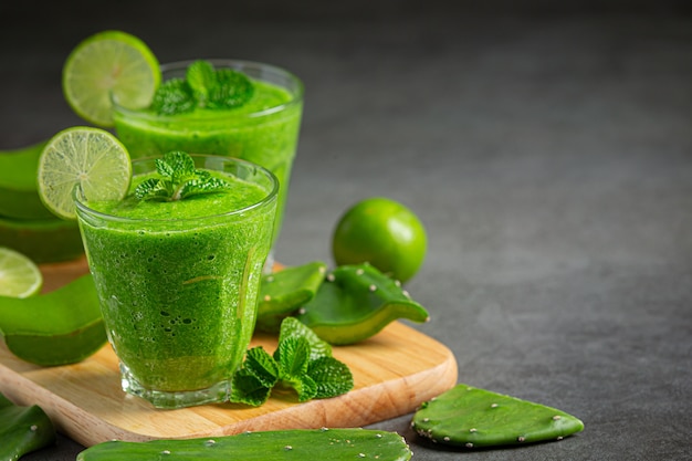 Two glasses of aloe vera  juice put on wooden cutting board