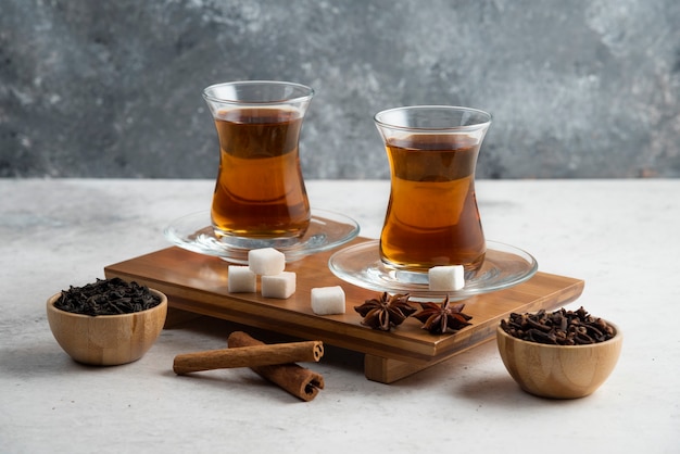 Two glasses cup of tea with sugar and star anise.