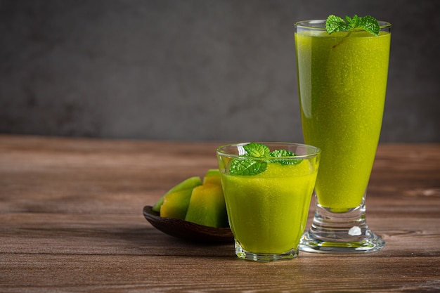 Two glasses of melon juice put on wooden floor