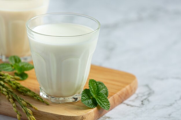 Two glasses of rice milk with rice plant put on wooden bord