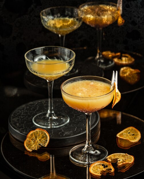 Two glasses with long stem of orange cocktail with pulp