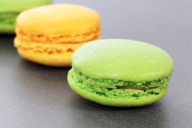 Two green and yellow macaroons in kitchen