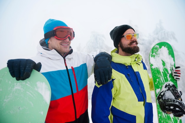 Two guys with snowboards during winter break