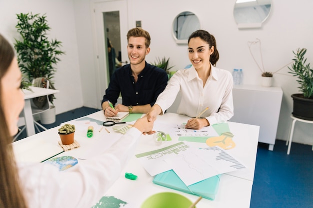 Two happy businesswoman shaking hands during business meeting