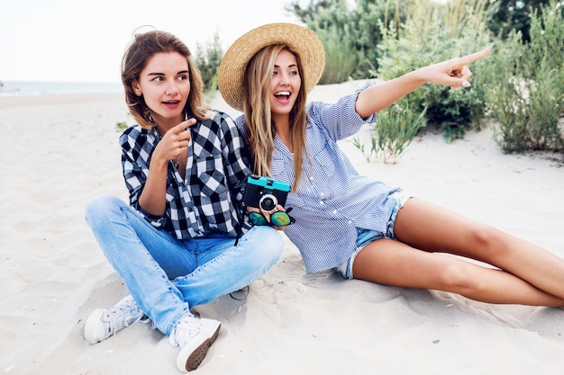 Free photo two happy female friends having fun on beach