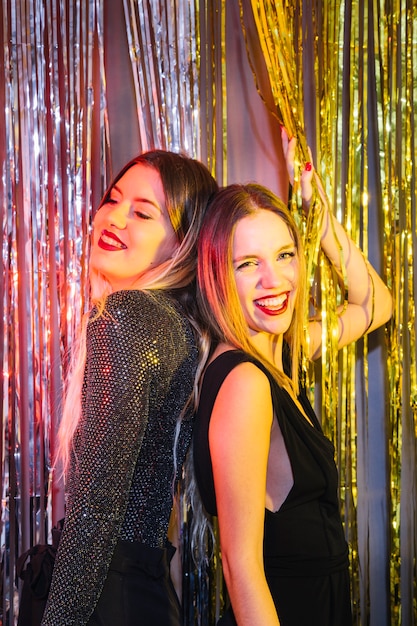 Two happy friends dancing at new year party