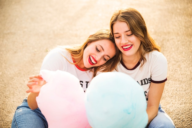 Two happy lesbian couple with candy floss