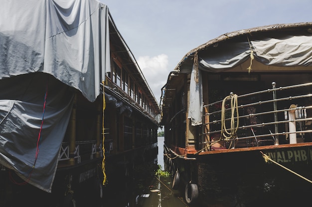 Two house boats docked next to each other