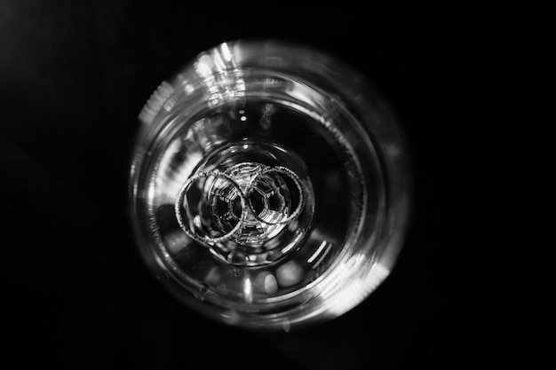 Free Photo two identical wedding rings lie at the bottom of a glass