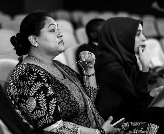 Free photo two international business women sitting in a conference room