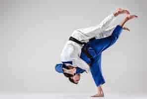 Free photo the two judokas fighters fighting men