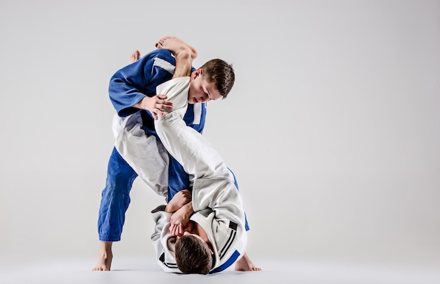 The two judokas fighters fighting men