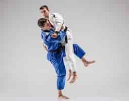 Free photo the two judokas fighters fighting men