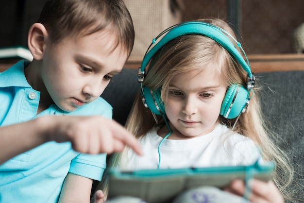 Two kids playing with tablet