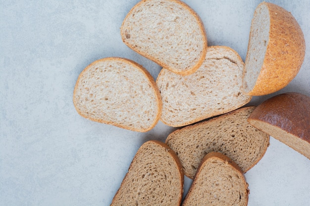 Two kinds of bread slices on marble background. High quality photo