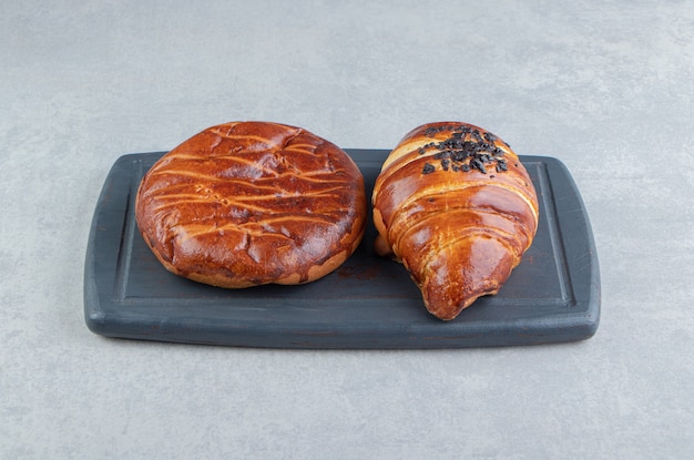 Two kinds of pastries on black board.