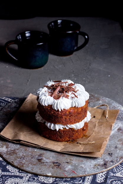 Two layered dessert with white cream topped with grated chocolate