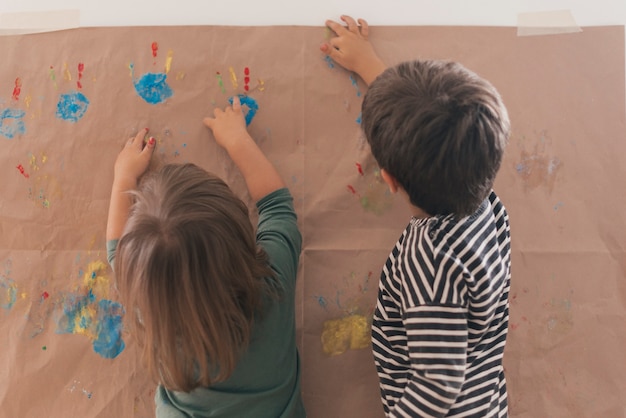 Two little childs painting together