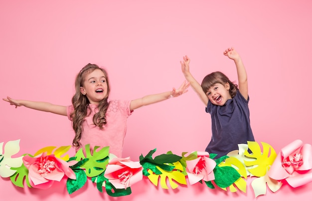 two little girls on summer pink wall