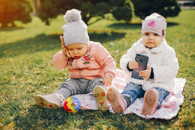 Free Photo two little sisters in a park