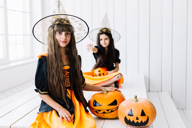 Free photo two little witch at halloween party