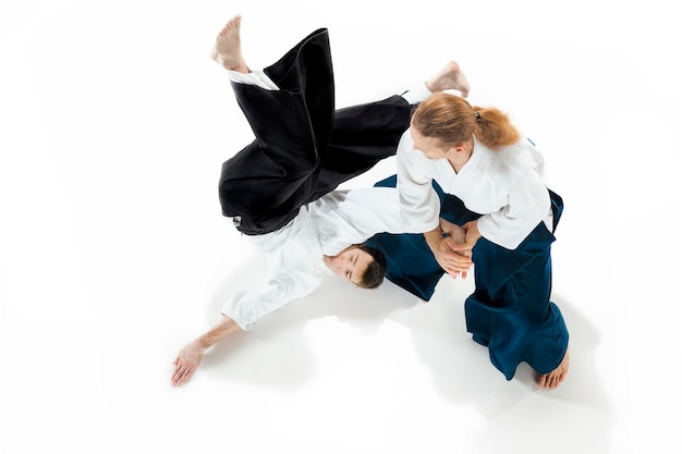 Free photo the two men fighting at aikido training in martial arts school