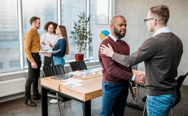 Two men handshaking in agreement after a meeting