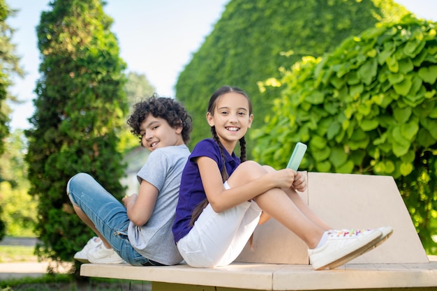 Two modern teens enjoying their leisure in the park