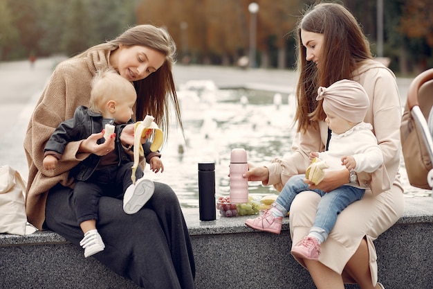 Two mothers with little children spend time in a park