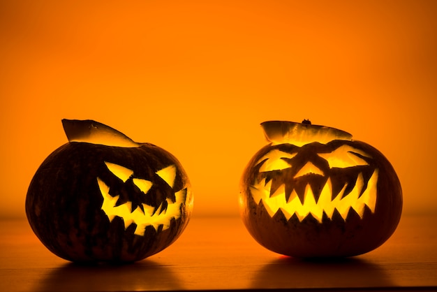 Two opened jack-o-lanterns with candles