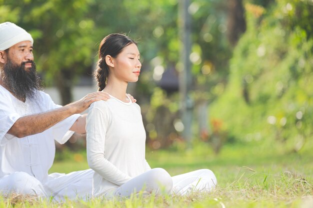 Two people in white outfit doing massage with relaxing emotion