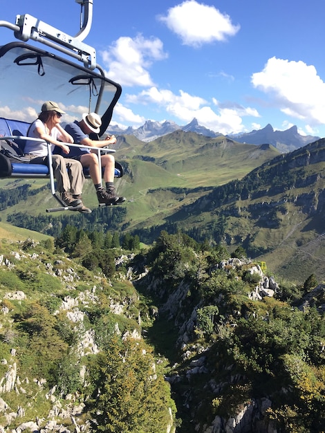 Two person riding on cable car