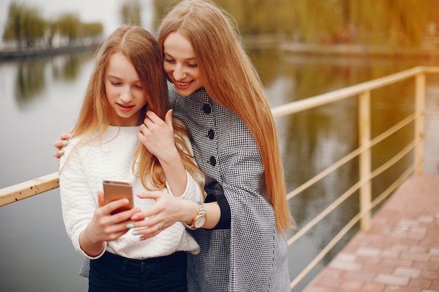 two pretty sisters in a park