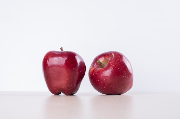 Free photo two red apples on white.