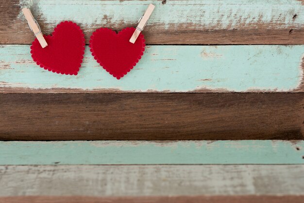 Two red hearts with wood clip