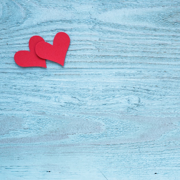 Free photo two red hearts on wooden table