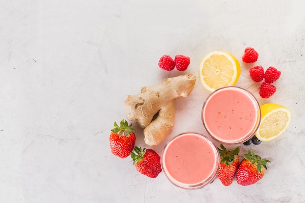 Free photo two red smoothies with strawberries and ginger