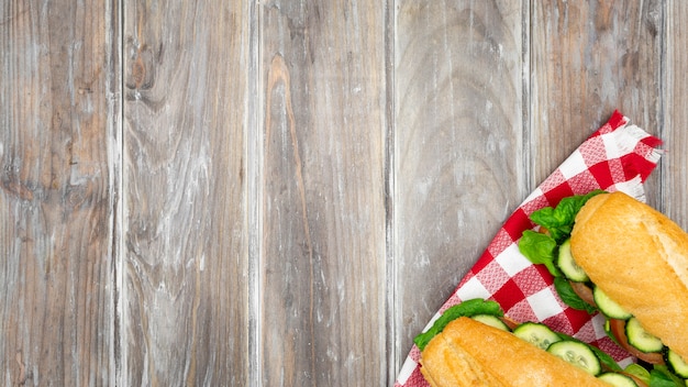 Two sandwiches on tablecloth with copy space