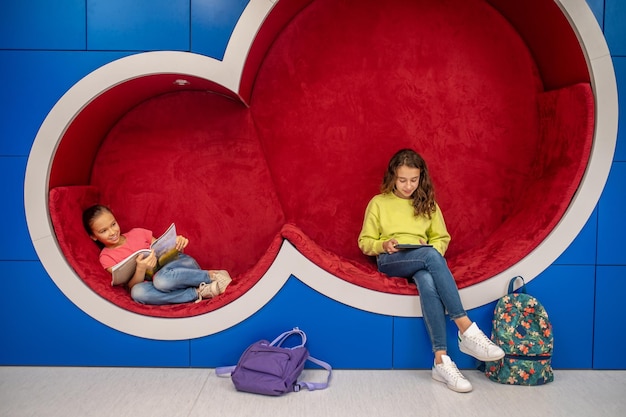 Free Photo two schoolgirl resting in recreation area