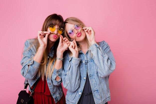 Two sisters having fun and making grimace