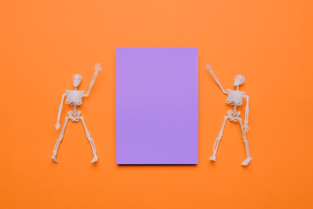 Free photo two skeletons of halloween with purple